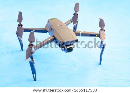 Drone quadrocopter on the blue surface of the plaster with mounted high resolution camera. It is new technology for aerial photo and video.