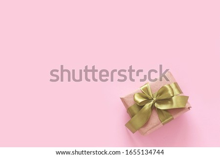 Gift minimalism template on a colored background with a bow. View from above. Place for text, template for banner, poster.