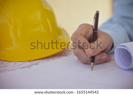 Supervisor holding pen writing on paper document working,Close up hand write paperwork