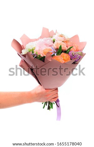 Mans hand holding Bouquet of mixed spring flowers  isolated on white background 
