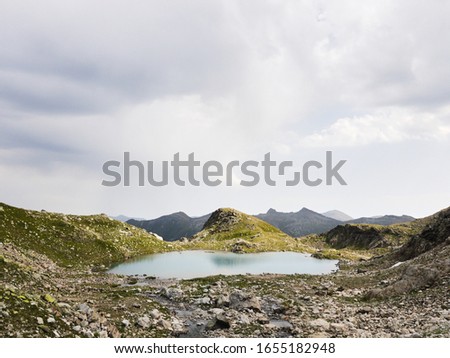 Alpine turquoise lake, surrounded by rocks. Karachay-Cherkessia, Arkhyz. Russia. High quality photo