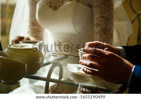 Girl bride drinks coffee on wedding morning