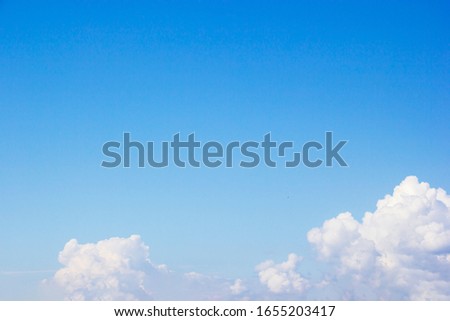Blue sky background and white clouds soft focus, and copy space.