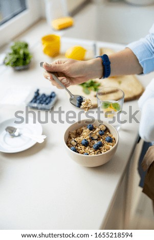 Top view of lady holding baby while making breakfast stock photo