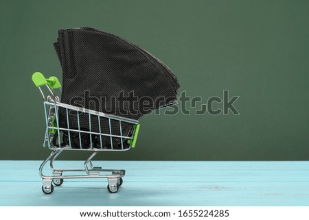 shopping cart with medical face masks concept of buying masks and respirators