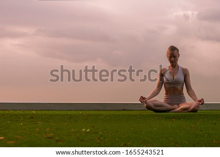 Close up of hand, The beginner yoga in basic yoga pose.The position required stretching, balance. The flexibility exercises is for health, wellness. Happy young woman doing yoga exercise outdoor.