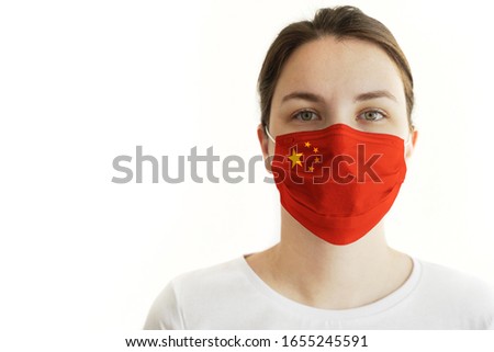 Coronavirus COVID-19. Young Woman With Face Mask and Chinese Flag.
