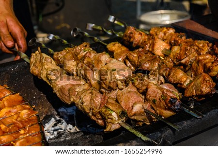 Skewers with meat over charcoals. Cooking shashlik