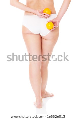 A picture of a back of an adult woman standing over white background with two oranges