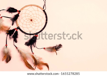 Dream Catcher on pink background with copy space.
