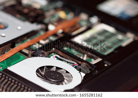 Close up of laptop fan with dust on laptop motherboard pc RAM memory cards hard drive internal...