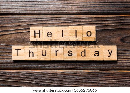 hello thursday word written on wood block. hello thursday text on wooden table for your desing, concept.