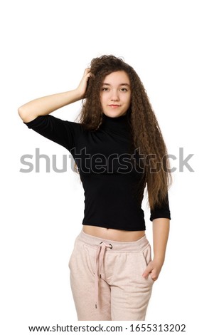 Cute teenager girl with long curly hair, on a white background