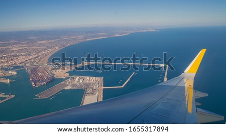 Airplane window overlooking the horizon Royalty-Free Stock Photo #1655317894