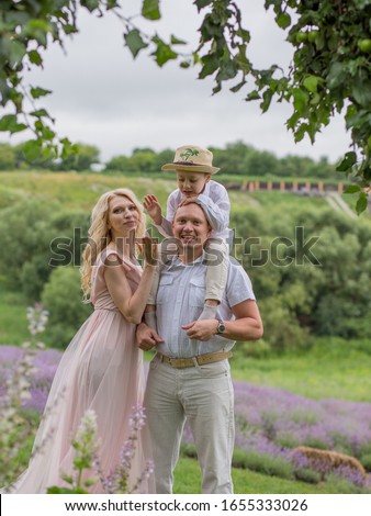 
happy family with little son in lavender field, enjoy nature and relaxation