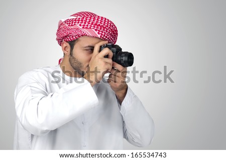Arabian photographer taking pictures isolated