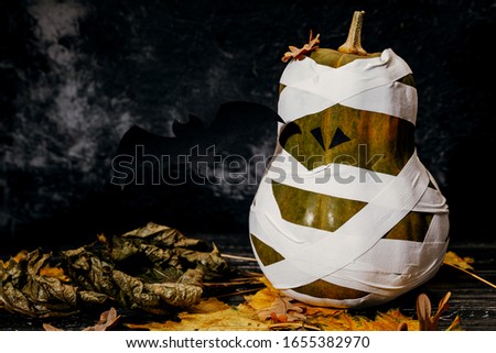 Zombie pumpkins in bandages, on a dark background. The concept of Halloween.