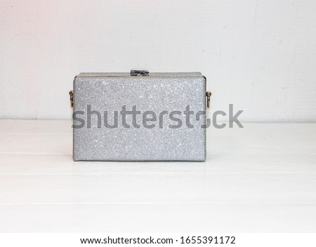 Glittery silver clutch bag isolated on white background with copy space.