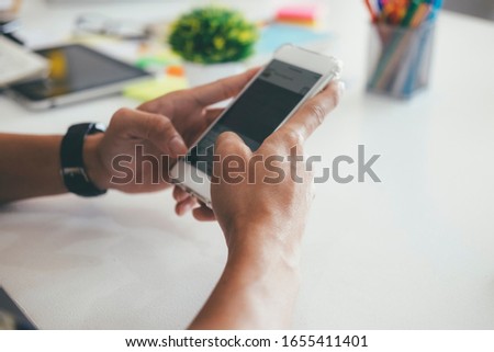 Closeup hand using  mobilephone.  Using online connect technology for business, education and communication.  Royalty-Free Stock Photo #1655411401