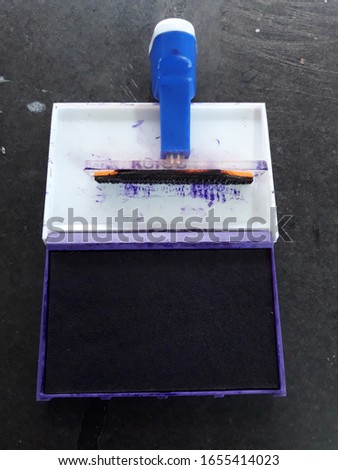ink  pad with rubber stamp down position. 