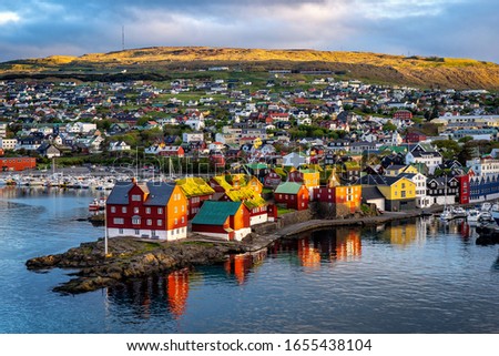 Sunrise scene of capital city Torshavn in Faroe Islands in North Atlantic. Urban scene of scandinavian city in warm golden sunlight. Royalty-Free Stock Photo #1655438104