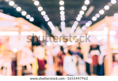 Vintage tone Abstract Blurred Shopping mall or Exhibition hall with bokeh for background usage.