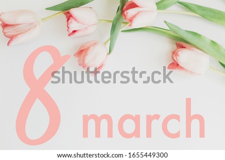 8 march. Happy womens day floral greeting card. 8 march text on pink tulips stylish border flat lay on white background. Handwritten lettering. International women day