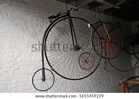 A vintage bicycle hanging in an old garage.
