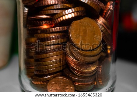 Zoom of copper money coins in a small glass jar. Close-up of coins in a jar. Qapik - monetary unit of Azerbaijan. 1, 3, 5 qapiks