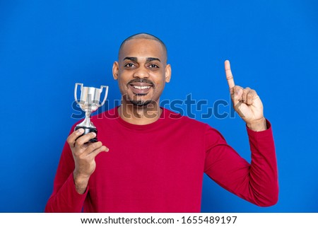 African guy with a red jersey on a blue background