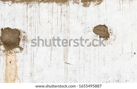 Texture of old white stucco wall with stains of clay, background.