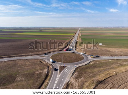 Aerial drone view of traffic roundabout in Vojvodina,Serbia. New road near city of Subotica. Royalty-Free Stock Photo #1655553001