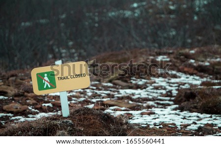 Yellow Hiking Trail Closed Sign in The Ground 