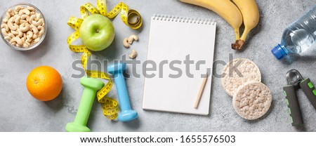 Fitness and healthy eating concept with blank notepad