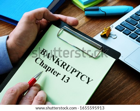 Man reads bankruptcy chapter 13 law in the office. Royalty-Free Stock Photo #1655595913