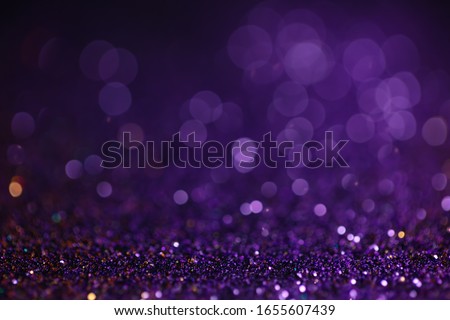 Decoration bokeh glitters background, abstract glowing backdrop with circles,modern design wallpaper with sparkling glimmers. Black, purple and golden backdrop glittering sparks with glow effect Royalty-Free Stock Photo #1655607439