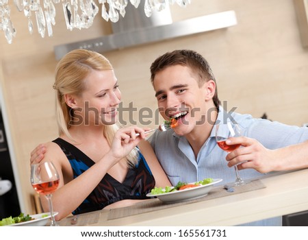 Married couple has romantic supper in the kitchen