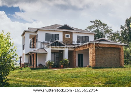 Suburban luxury house in middle of nature  Royalty-Free Stock Photo #1655652934