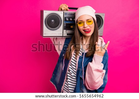 Close-up portrait of her she nice attractive cheerful cheery girl carrying boombox showing horn sign grimacing having fun isolated on bright vivid shine vibrant pink fuchsia color background
