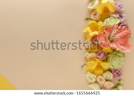 top view of spring floral border on beige and yellow background