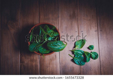
fresh spinach with wooden background. Ecological concept. From above.