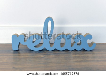 wooden blue relax inscription on a white rug