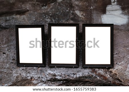 
3 empty picture frames on the cave wall