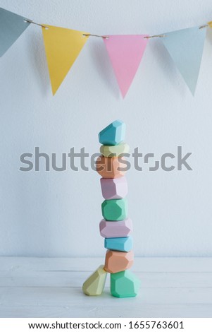 Wooden stones. Children's game. Colorful wooden figurines. A bright background of four colors.