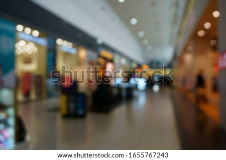 Blurred background. People buy products at the Mall. Shopping center. Shopping center gallery. Beautiful interior. Walk to the shops.
