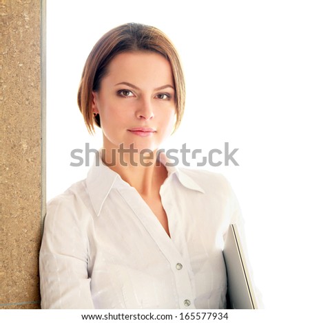 Portrait of young busineswoman standing in office lobby