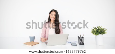 Portrait smile beautiful business asian woman in pink suit working in office desk virtual computer. Small business owner people employee freelance online sme marketing e-commerce telemarketing concept Royalty-Free Stock Photo #1655779762