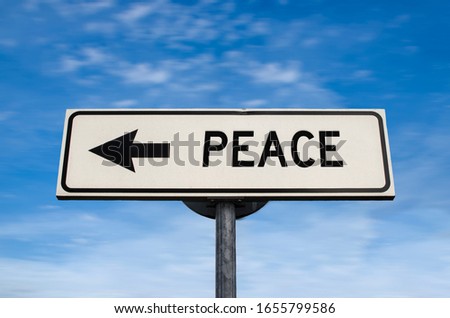 Peace road sign, arrow on blue sky background. One way blank road sign with copy space. Arrow on a pole pointing in one direction.
