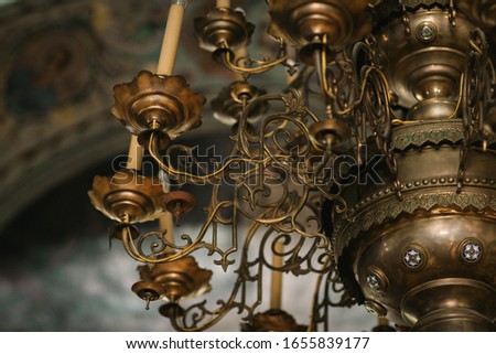 candelabra for candles in the orthodox church on the background of the dome.chandelier in the church. church attributes. the interior of the temple.