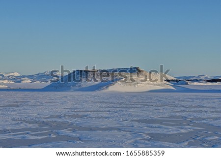 View of Mývatn area in winter time, frozen lake, mountains and craters, Iceland